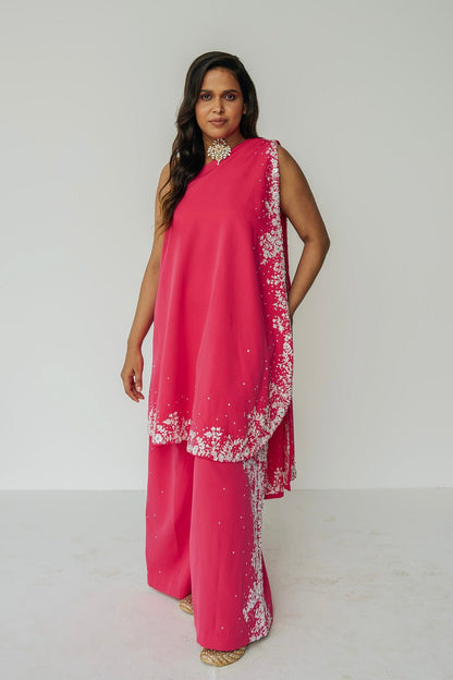 The Cleo Set consists of one shoulder top with hand-embroidered, high-waisted pants, and a detachable drape.