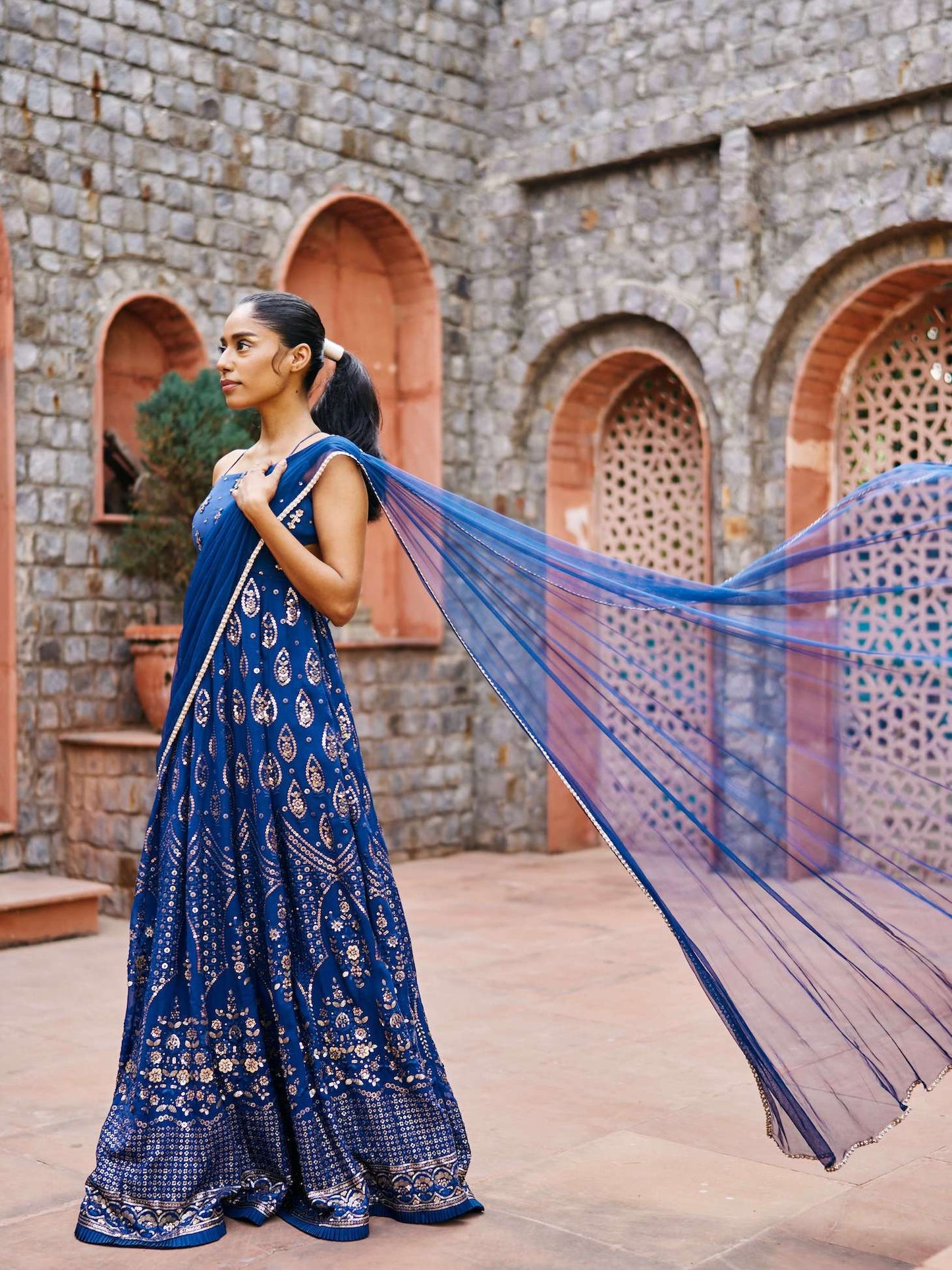 The Cutout Anarkali is an open-back, sequin gown paired with an attached dupatta (so you can't lose or trip on it). 