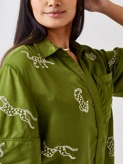 Woman wearing a green, embroidered leopard loungewear short set.