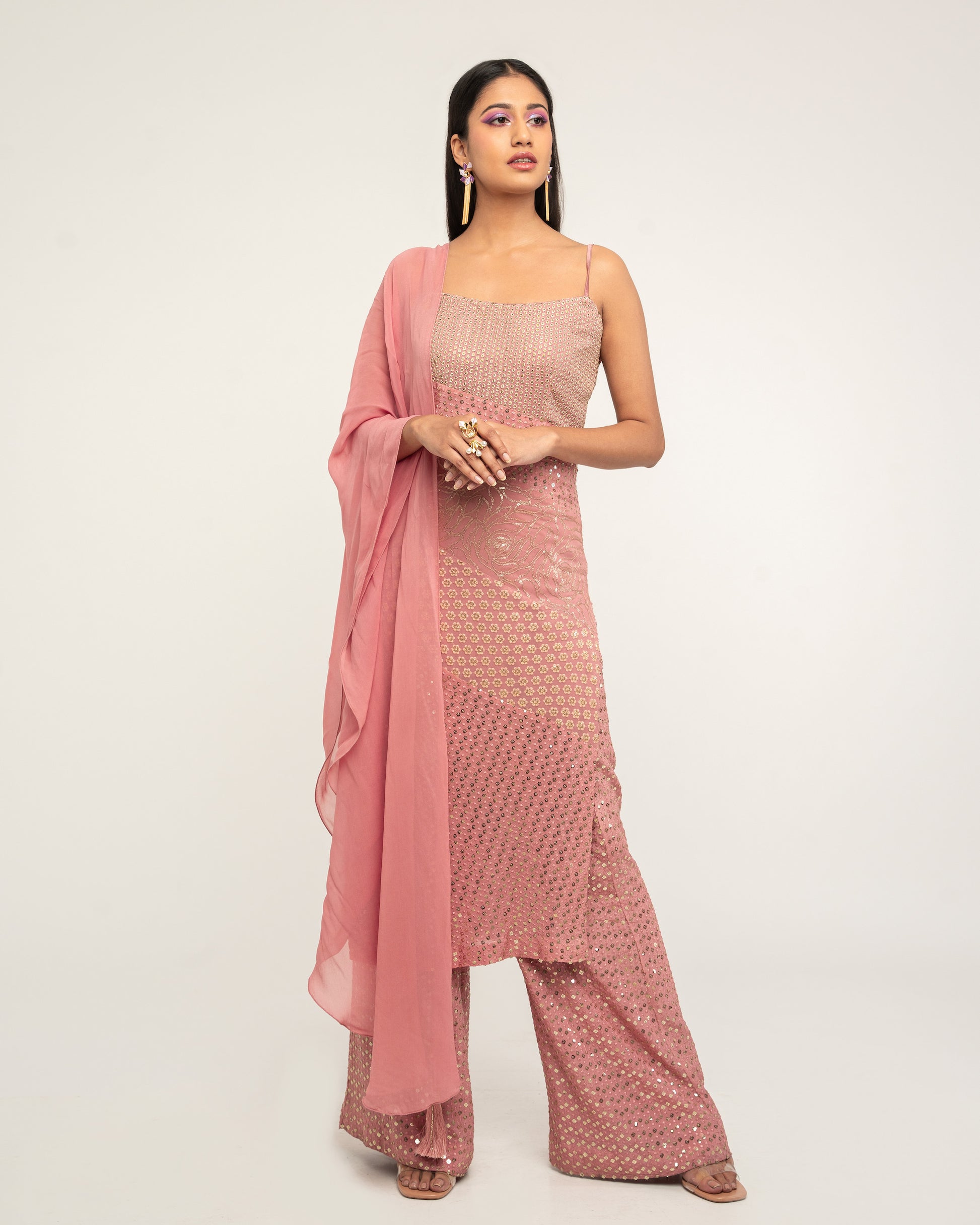 The Harleen Palazzo Set consists of a dress, palazzo pants, and a skinny dupatta. It is a patchwork design featuring 4 unique, embroidered fabrics. 