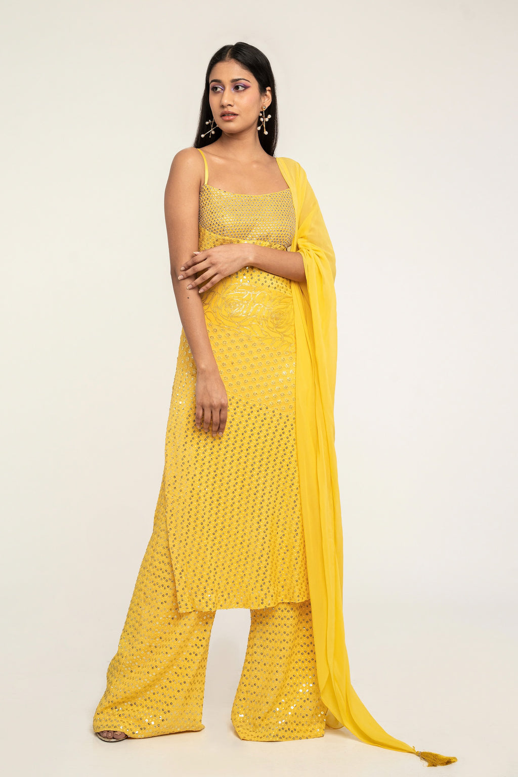 The Harleen Palazzo Set consists of a dress, palazzo pants, and a skinny dupatta. It is a patchwork design featuring 4 unique, embroidered fabrics.