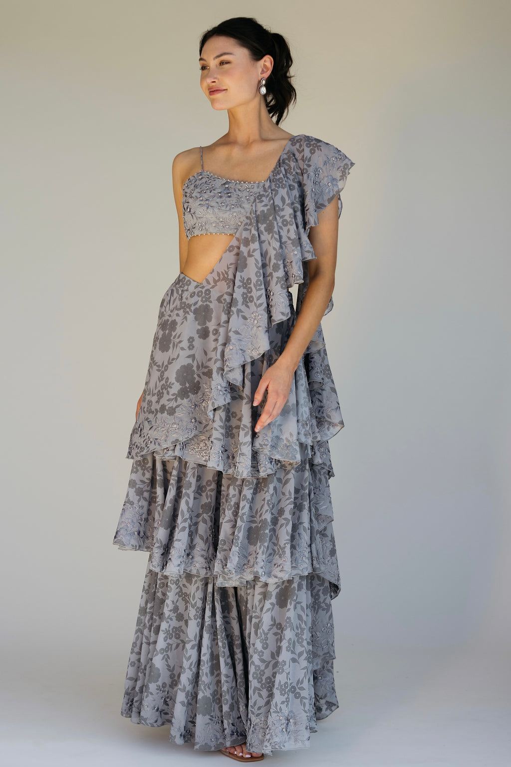 The Leela Palazzo featured a floral print with hand embroidered accents throughout. The look includes a pant with rufflied tiers and a dupatta, which are both paired back to a hand embroidered blouse with silver detailing.&nbsp;