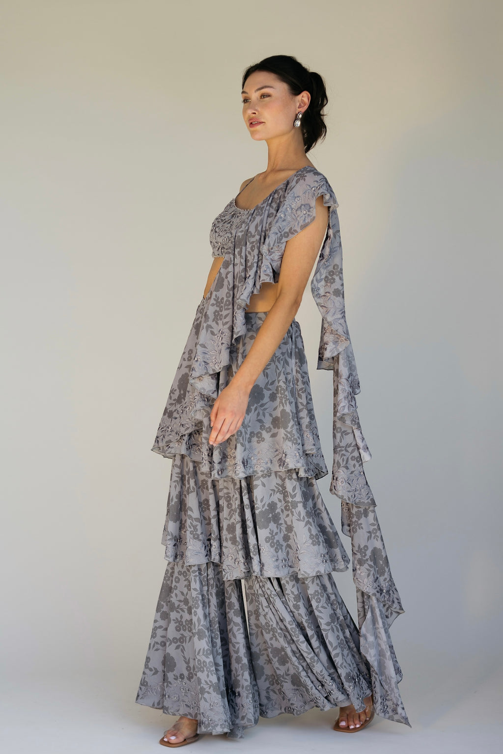 The Leela Palazzo featured a floral print with hand embroidered accents throughout. The look includes a pant with rufflied tiers and a dupatta, which are both paired back to a hand embroidered blouse with silver detailing.&nbsp;