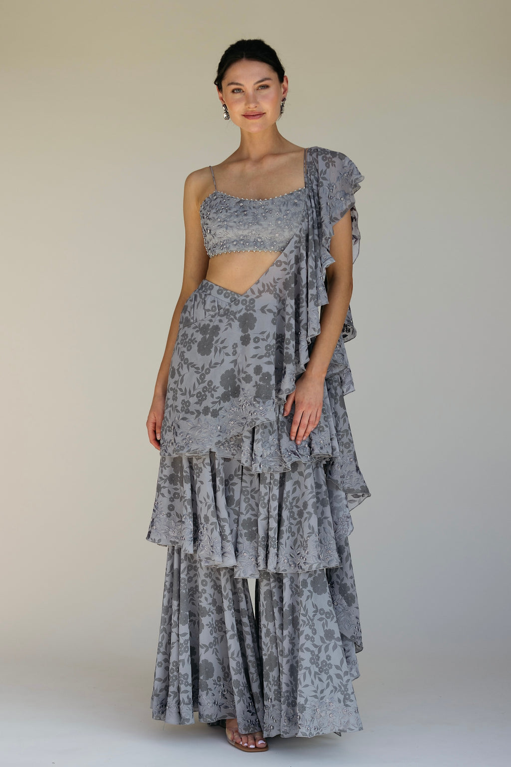The Leela Palazzo featured a floral print with hand embroidered accents throughout. The look includes a pant with rufflied tiers and a dupatta, which are both paired back to a hand embroidered blouse with silver detailing.&nbsp;