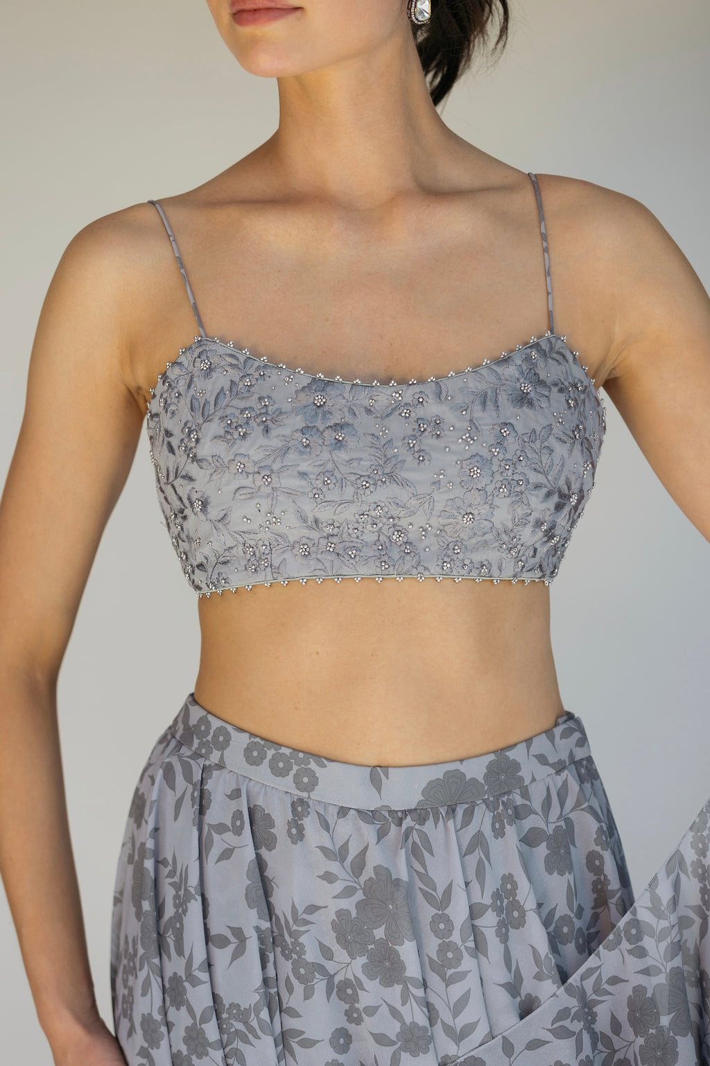 The Leela Palazzo featured a floral print with hand embroidered accents throughout. The look includes a pant with rufflied tiers and a dupatta, which are both paired back to a hand embroidered blouse with silver detailing.&nbsp;