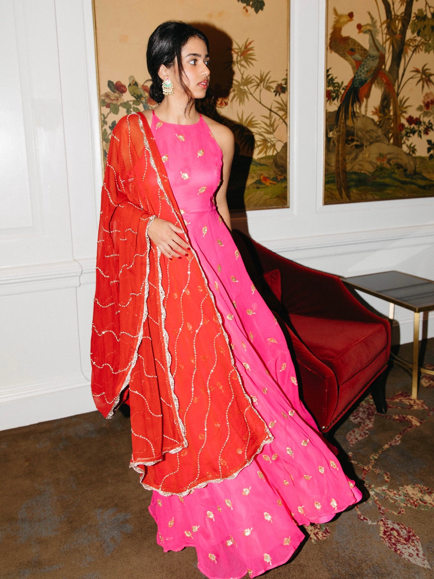 Nila Anarkali has a halter neck-cut, bodice, flowing waistline, and is paired with a contrasting silk crepe dupatta.
