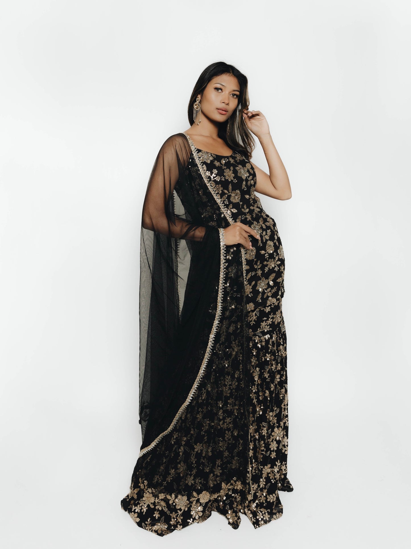 Woman in black and gold sequin outfit with Gharara pant, top, and dupatta