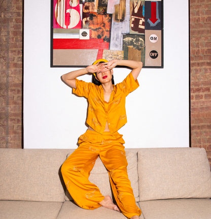 Marigold loungewear, woman sitting on top of couch 