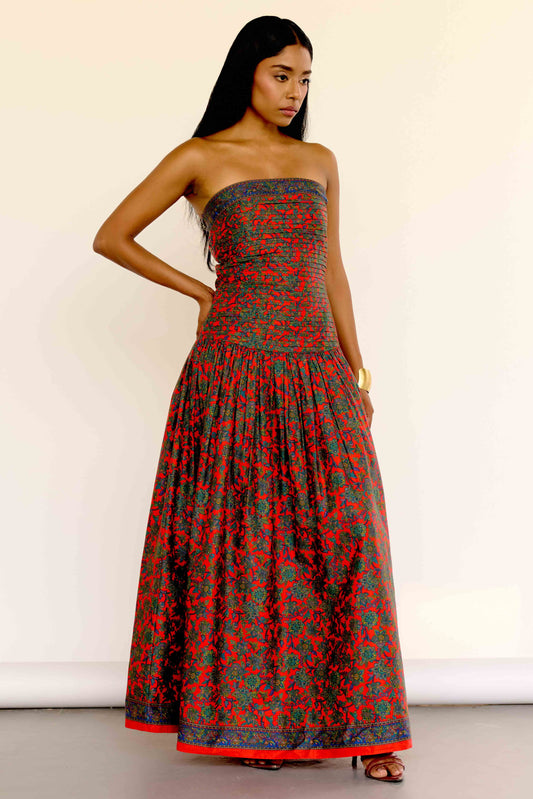 The Maya Dress features a vintage-inspired floral print. It’s strapless with a drop waist, a pleated bodice, and a softly gathered skirt.&nbsp;