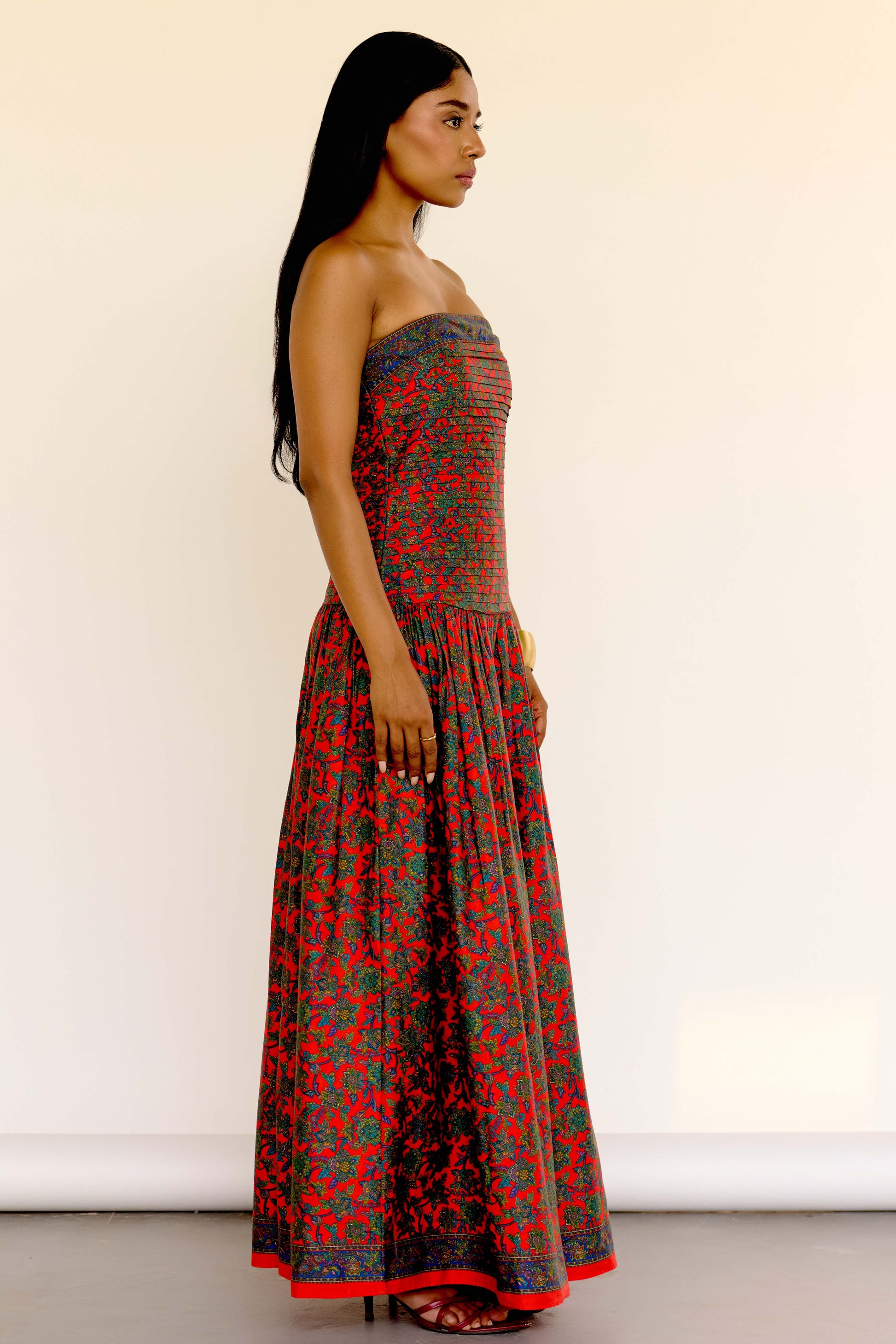 The Maya Dress features a vintage-inspired floral print. It’s strapless with a drop waist, a pleated bodice, and a softly gathered skirt. 