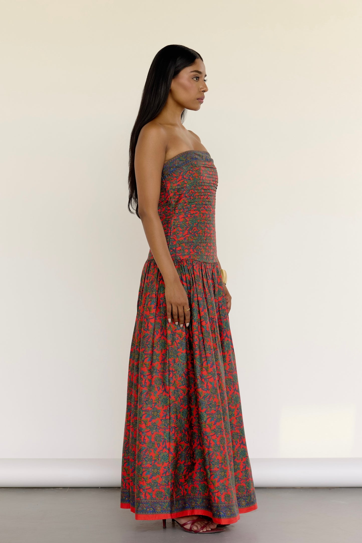 The Maya Dress features a vintage-inspired floral print. It’s strapless with a drop waist, a pleated bodice, and a softly gathered skirt. Choose the beaded version for extra shimmer with hand-done embroidery that follows the floral pattern, or go for the non-beaded if you’re feeling a little more laid-back.
