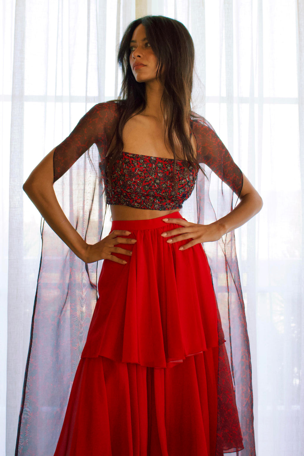 The Mirza Outfit includes a fully hand-beaded blouse with adjustable straps, tiered flared pants that add movement, and a sheer organza cape you’ll want to wear long after the event.