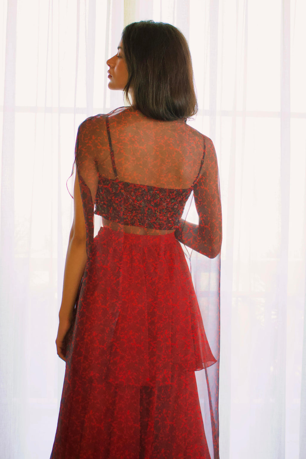 The Mirza Outfit includes a fully hand-beaded blouse with adjustable straps, tiered flared pants that add movement, and a sheer organza cape you’ll want to wear long after the event.