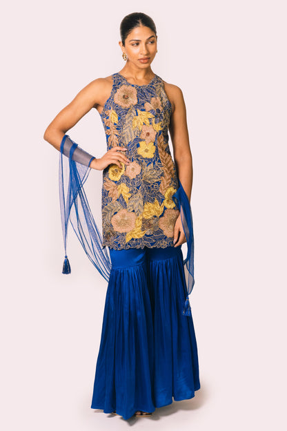 The Nidhi Gharara features intricate floral sequin work throughout the hand-embroidered mini dress, paired with silky gharara pants and a skinny dupatta. The outfit ALSO can be worn as a mini dress.