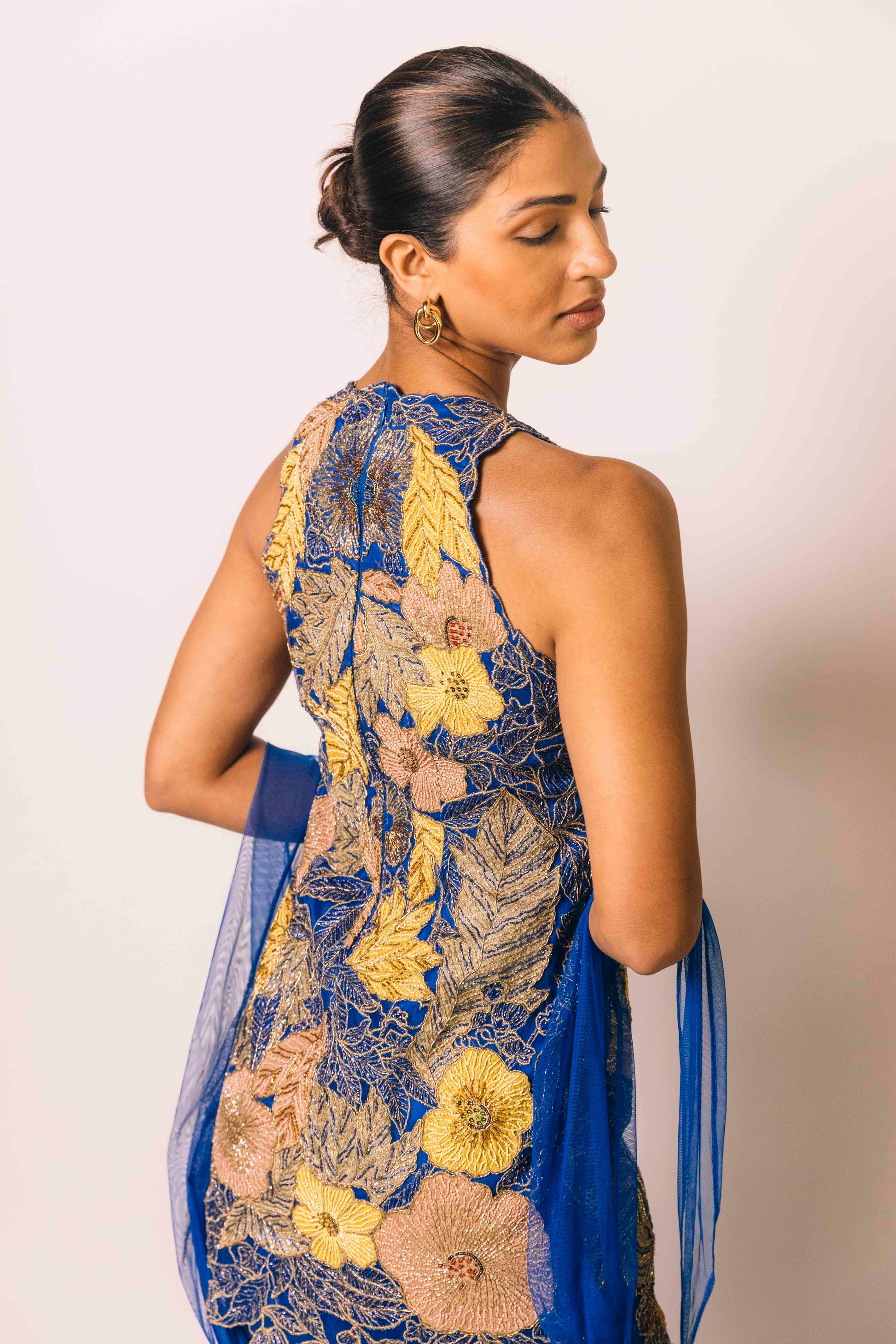 The Nidhi Gharara features intricate floral sequin work throughout the hand-embroidered mini dress, paired with silky gharara pants and a skinny dupatta. The outfit ALSO can be worn as a mini dress.