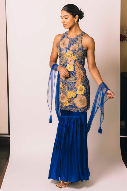 The Nidhi Gharara features intricate floral sequin work throughout the hand-embroidered mini dress, paired with silky gharara pants and a skinny dupatta. The outfit ALSO can be worn as a mini dress.