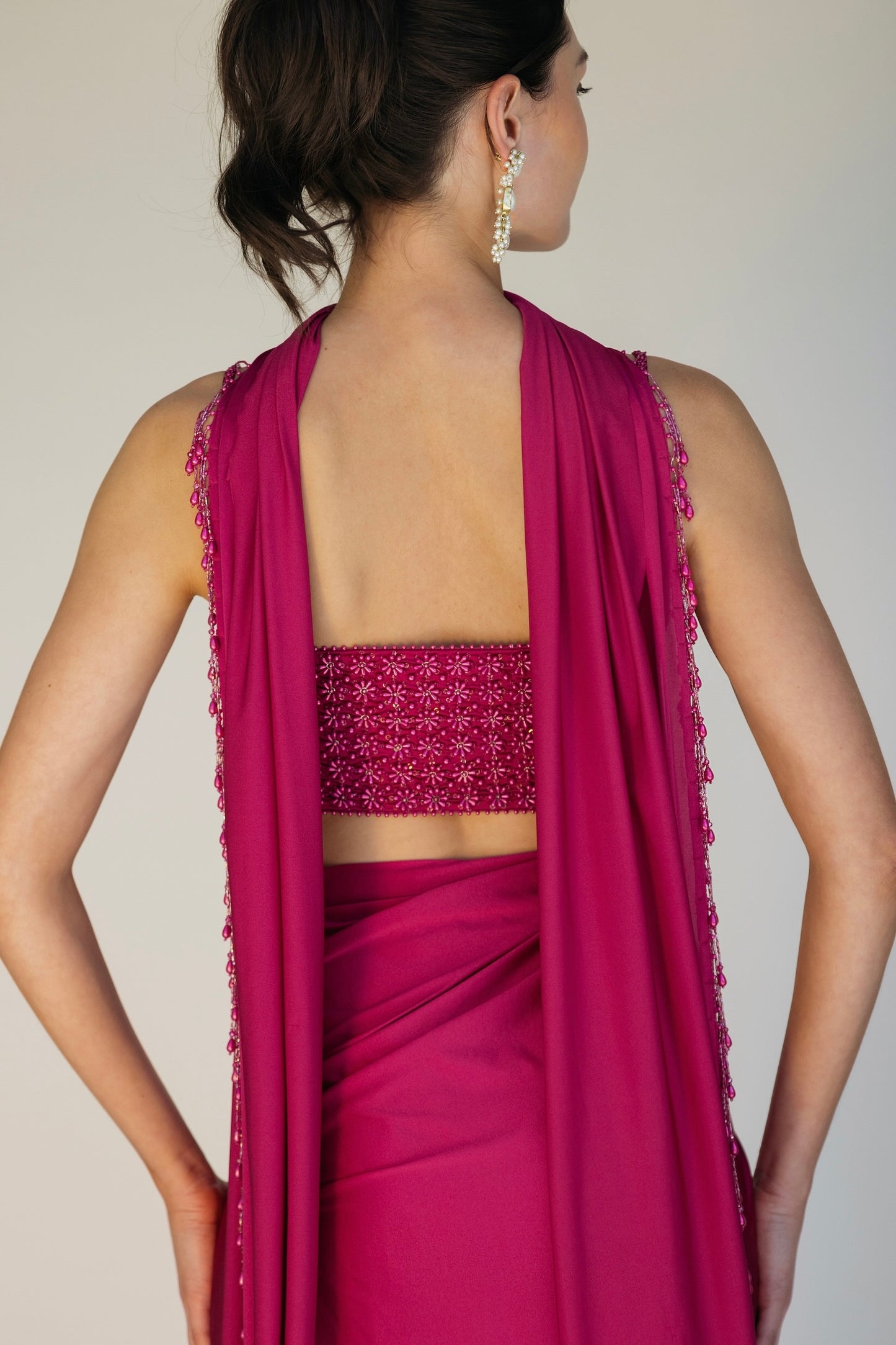 The Pearl Set features a hand embroidered pearl top, pleated skirt and skinny dupatta with pearl tassel detailing.