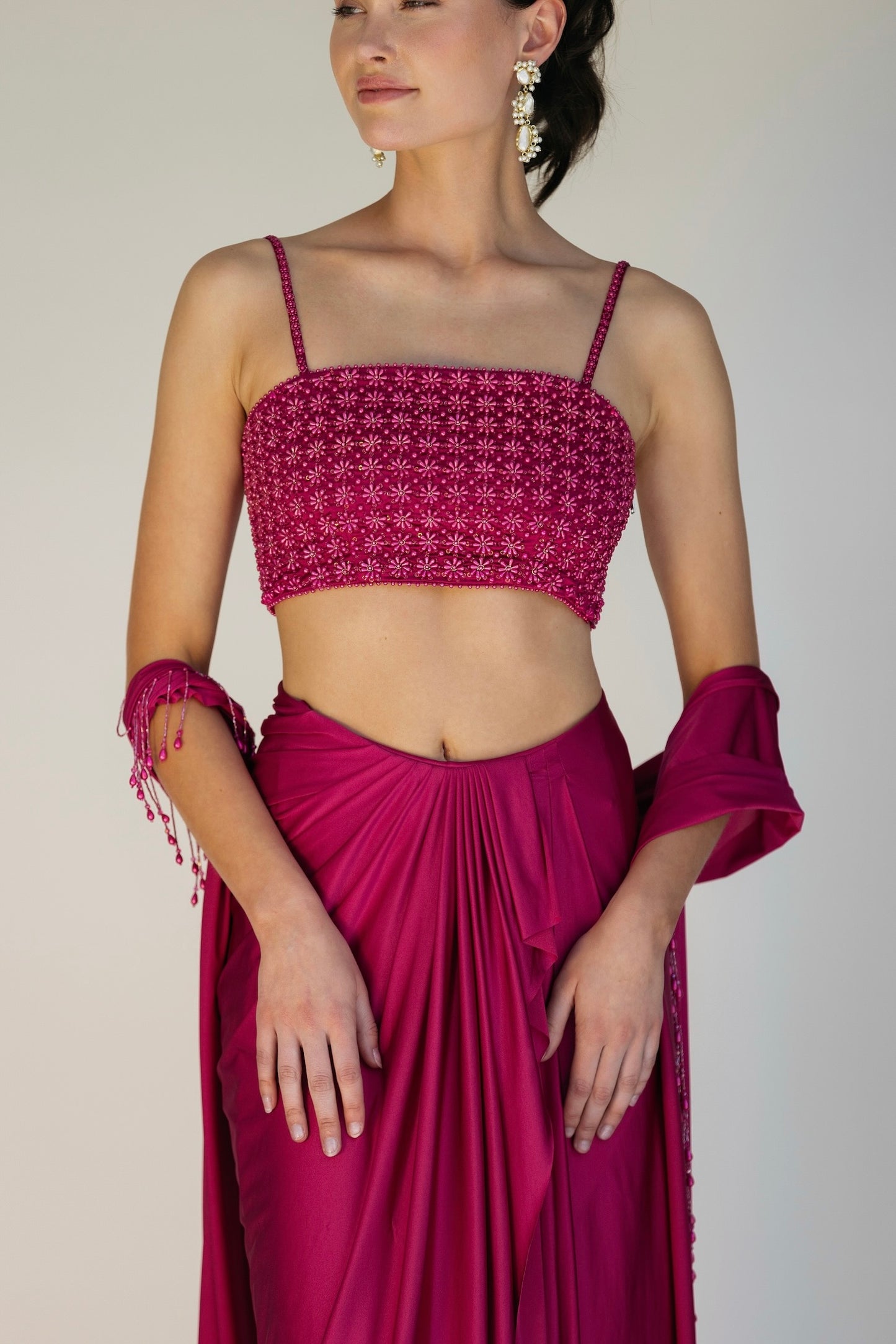 The Pearl Set features a hand embroidered pearl top, pleated skirt and skinny dupatta with pearl tassel detailing.