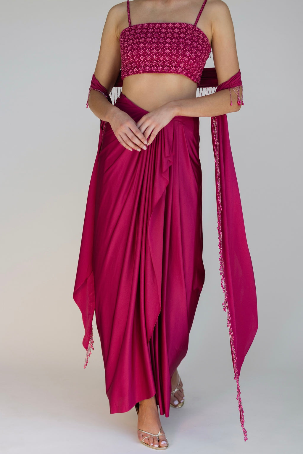 The Pearl Set features a hand embroidered pearl top, pleated skirt and skinny dupatta with pearl tassel detailing.