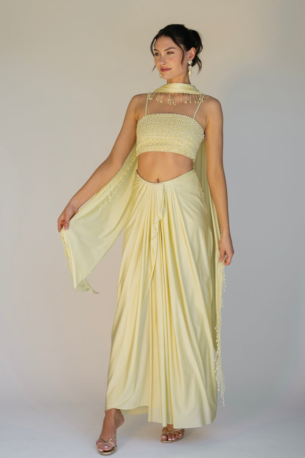 The Pearl Set features a hand embroidered pearl top, pleated skirt and skinny dupatta with pearl tassel detailing.