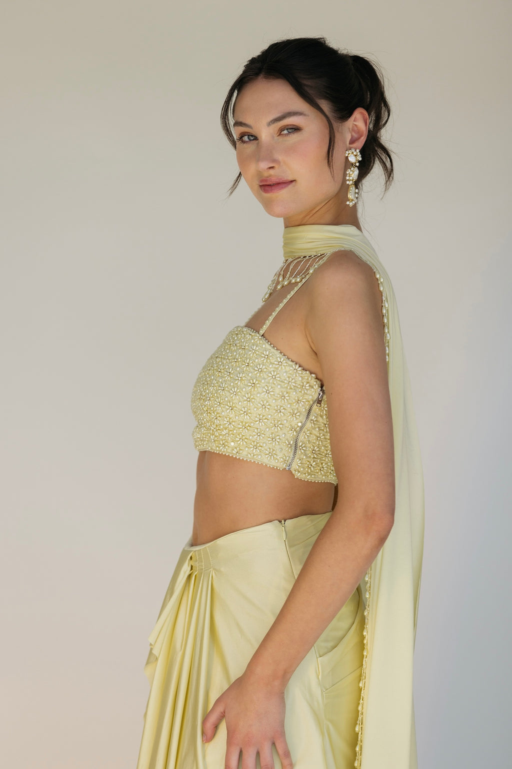 The Pearl Set features a hand embroidered pearl top, pleated skirt and skinny dupatta with pearl tassel detailing.
