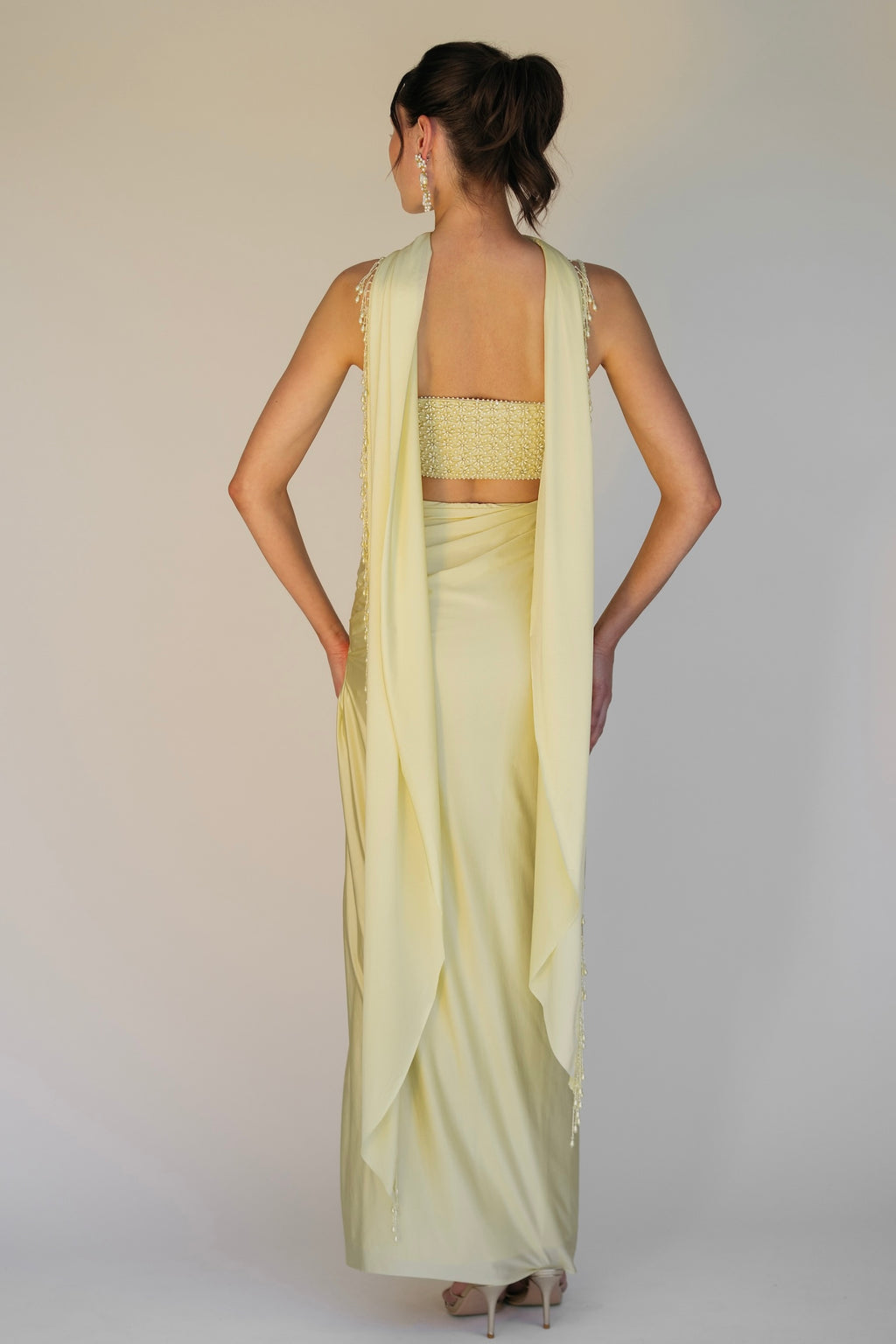 The Pearl Set features a hand embroidered pearl top, pleated skirt and skinny dupatta with pearl tassel detailing.