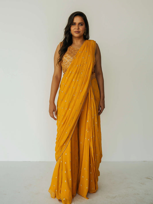 The Rani Palazzo 2.0 gives you the drape of a saree without any hassle. Featuring an all over embroidery on the pants and drape, and the blouse includes sequin work with accent beading.