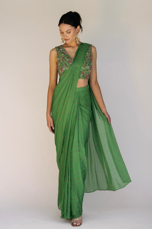 This saree has a hand-embroidered cropped top with intricate beadwork and sequins and is paired with a skirt featuring attached wraparound draping. This outfit is prestitched, so you can put it together in 30 seconds or less.
