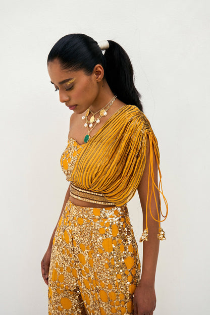 The sequined Tanvi Palazzo Set consists of a one-shoulder adjustable top and flared palazzo pants.