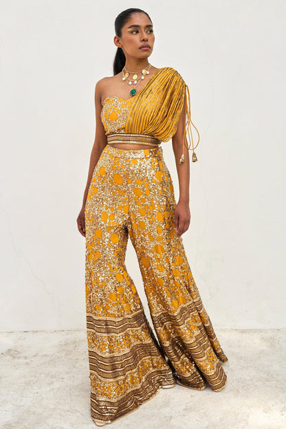 The sequined Tanvi Palazzo Set consists of a one-shoulder adjustable top and flared palazzo pants.