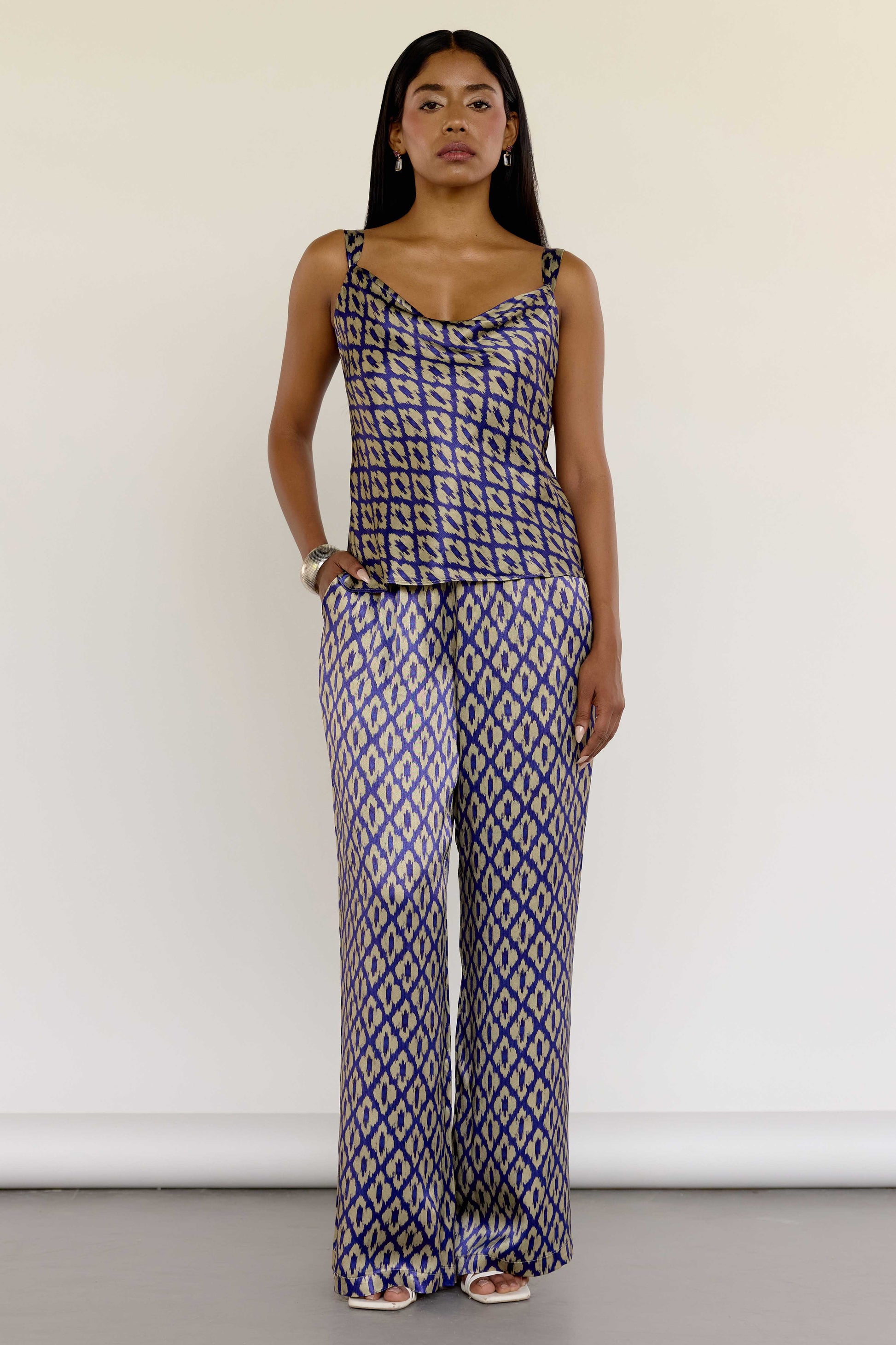 The Uma Pant features a vintage-inspired ikat print, drawn from a 1970s Indonesian handwoven ikat cotton scarf. With an adjustable waistband and a relaxed straight leg, these machine-washable pants pair effortlessly with the Uma Top or your favorite white top.