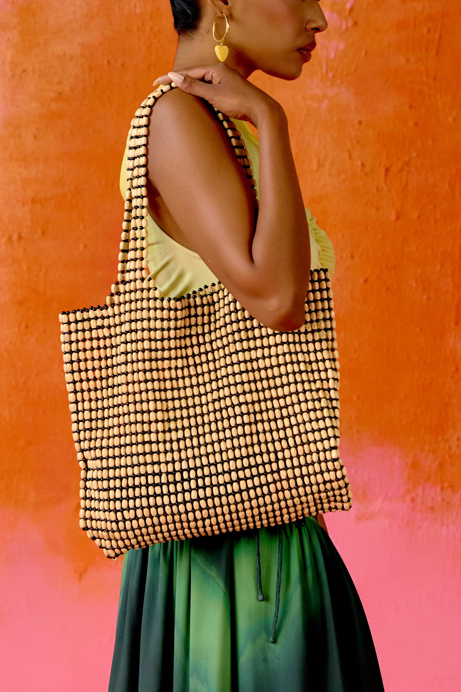 The bag you’ll reach for all summer long. Hand-assembled with smooth wooden beads, the Tula Tote is roomy, durable, and effortlessly chic. Its wide silhouette fits all your essentials (and then some), while the intricate beads add just the right touch of texture.
Whether you’re heading to the market, the beach, or brunch it’s functional, flattering, and made with love. 