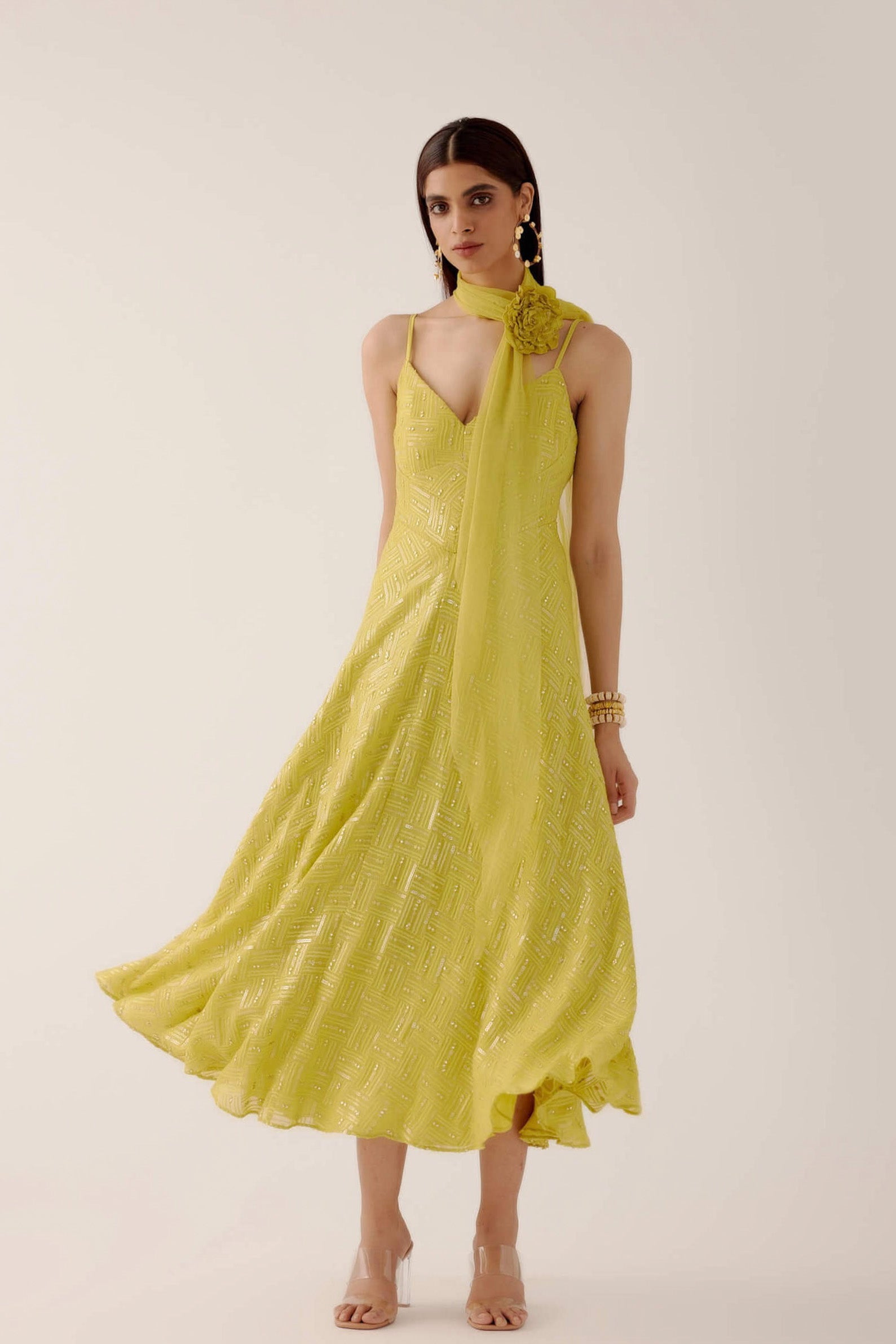 The Zara Dress is a midi-length dress with delicate sequin work throughout. The dress comes with a skinny dupatta and a detachable, handmade rosette clip. 