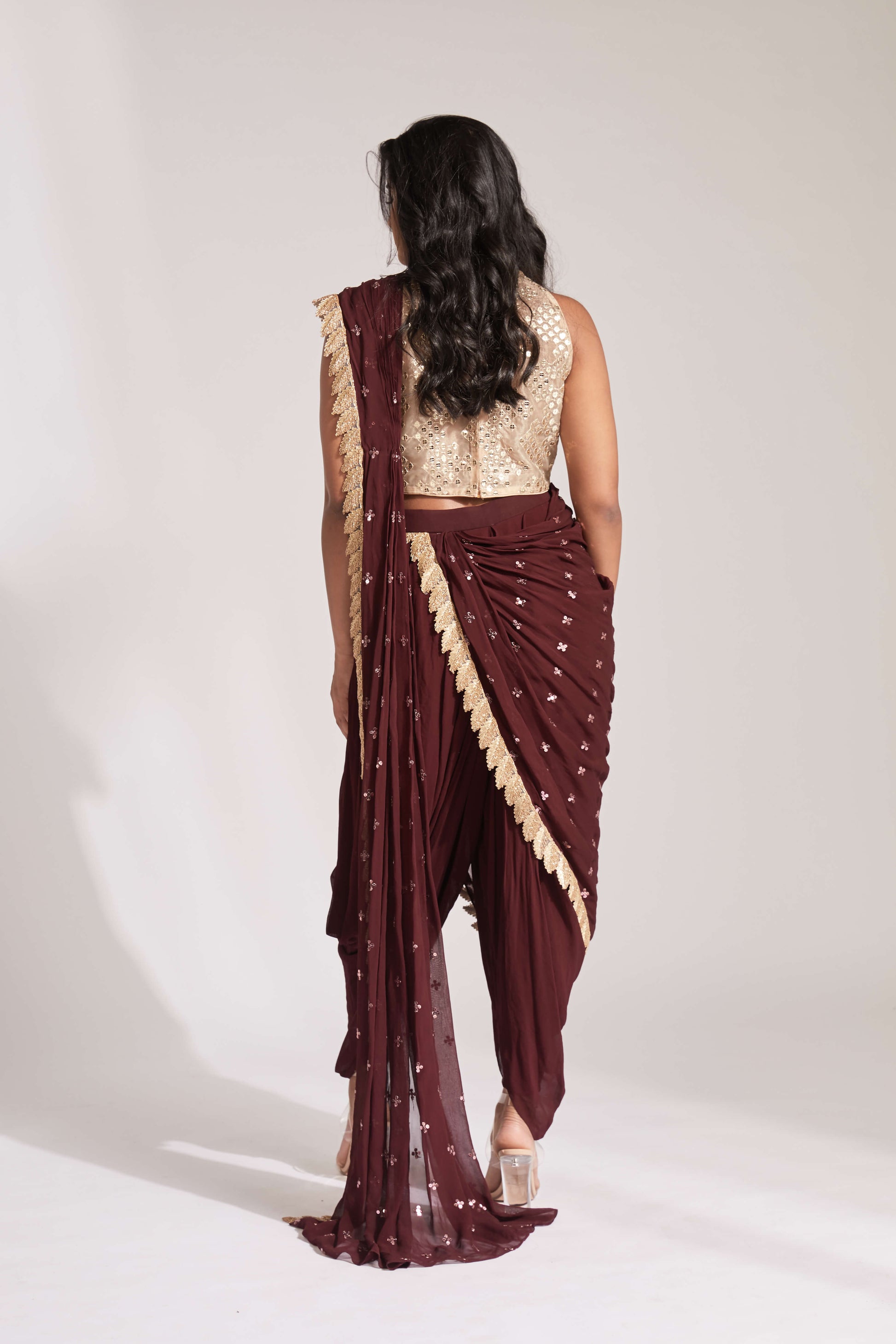 Dhoti pant outfit with attached drape and nude mirror work halter-style blouse
