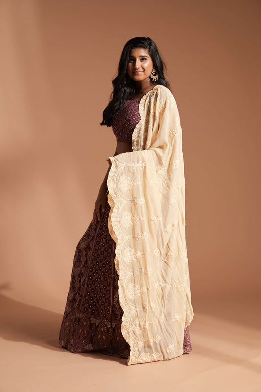Burgundy lehenga made with lucknowi/chikankari work and featuring a cap sleeve blouse and cream scallop dupatta
