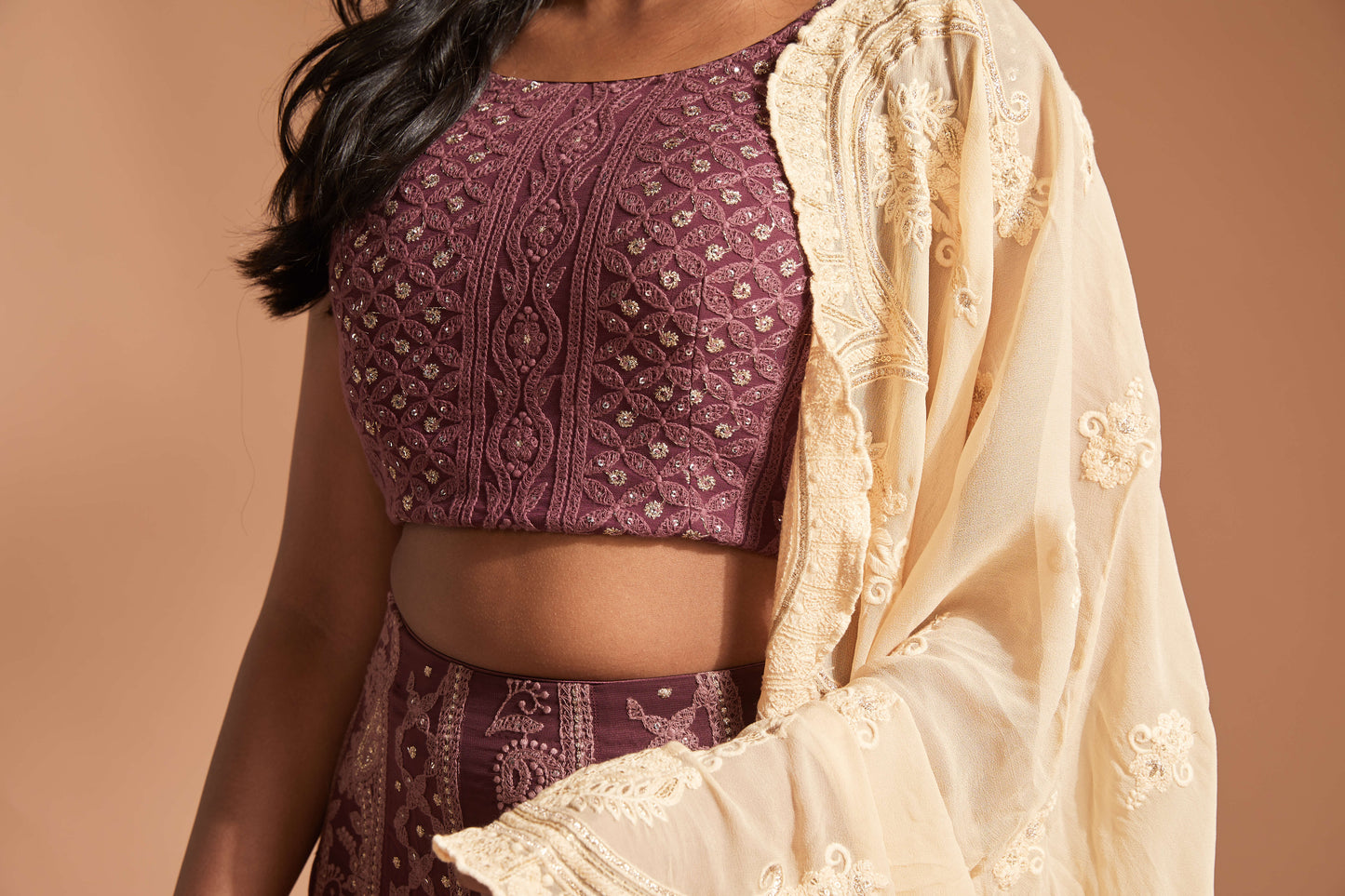 Burgundy lehenga made with lucknowi/chikankari work and featuring a cap sleeve blouse and cream scallop dupatta