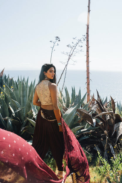 Dhoti pant outfit with attached drape and nude mirror work halter-style blouse