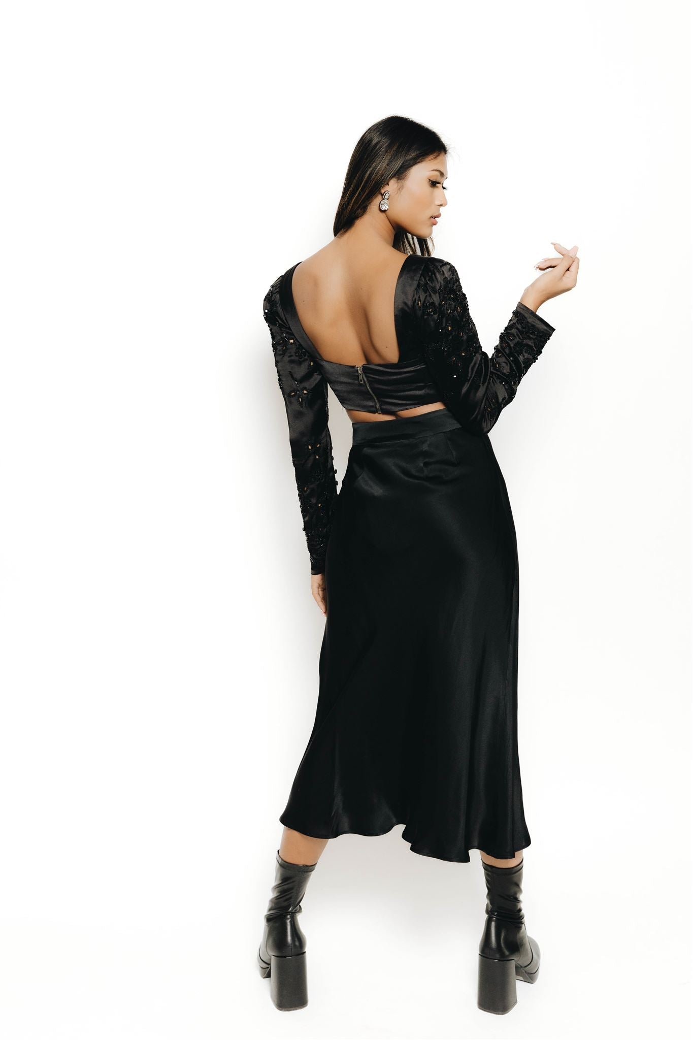 The Rani top is a long sleeve blouse with embellishment and cut work on the sleeves. Dress it up and down, this blouse is the perfect complement to a night out to your next reception. 