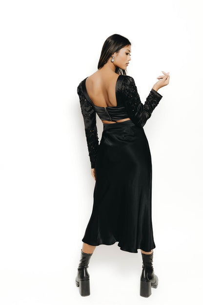 The Rani top is a long sleeve blouse with embellishment and cut work on the sleeves. Dress it up and down, this blouse is the perfect complement to a night out to your next reception. 